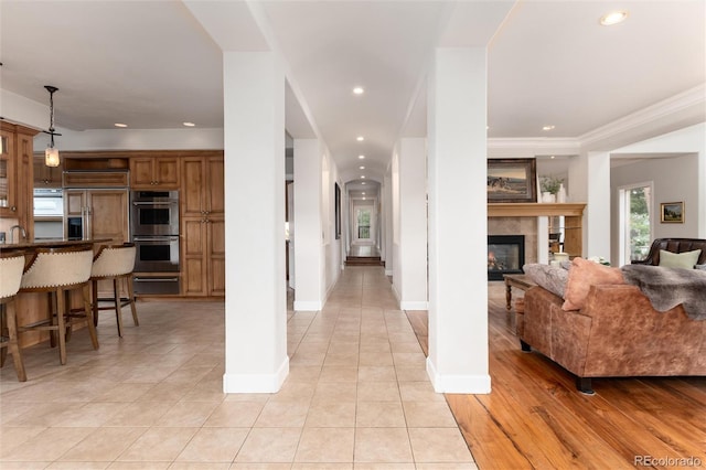 1425 Autumnwood Ln, Evergreen, CO 80439 - living area with light tile patterned floors, a glass covered fireplace, recessed lighting, and ornamental molding