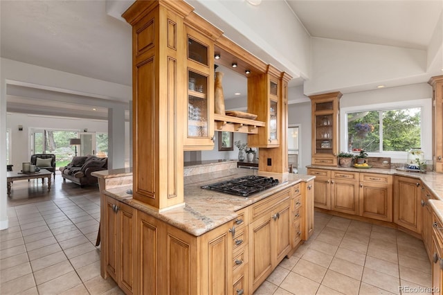 1425 Autumnwood Ln, Evergreen, CO 80439 - kitchen with stainless steel gas stovetop, light tile patterned floors, light stone countertops, glass insert cabinets, and lofted ceiling