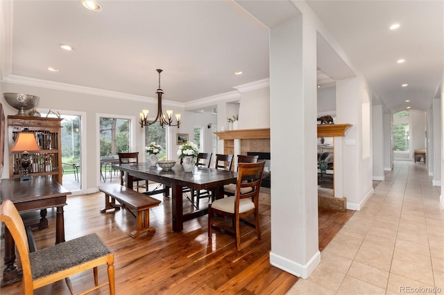 1425 Autumnwood Ln, Evergreen, CO 80439 - dining room featuring a tile fireplace, healthy amount of natural light, a chandelier, recessed lighting, and ornamental molding