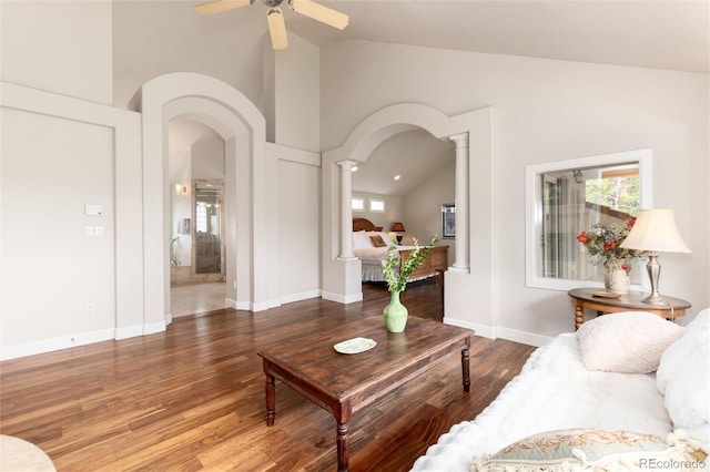 1425 Autumnwood Ln, Evergreen, CO 80439 - living area with decorative columns, lofted ceiling, wood finished floors, arched walkways, and a ceiling fan