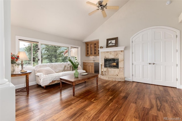 1425 Autumnwood Ln, Evergreen, CO 80439 - living area with high vaulted ceiling, ceiling fan, wood finished floors, and a fireplace