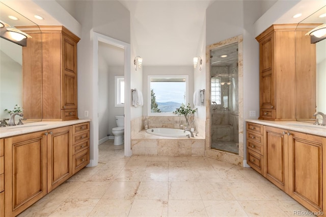 1425 Autumnwood Ln, Evergreen, CO 80439 - full bathroom featuring two vanities, a garden tub, a stall shower, and recessed lighting