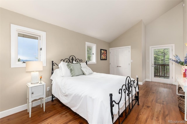 1425 Autumnwood Ln, Evergreen, CO 80439 - bedroom with access to exterior, wood finished floors, vaulted ceiling, and a closet