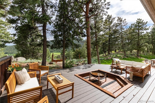 1425 Autumnwood Ln, Evergreen, CO 80439 - deck with an outdoor living space with a fire pit and view of scattered trees