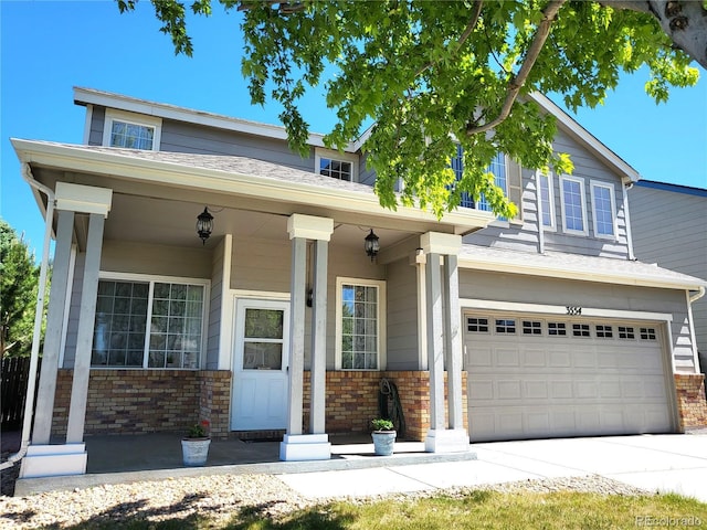 view of front of property featuring a garage, brick siding, a porch, and concrete driveway