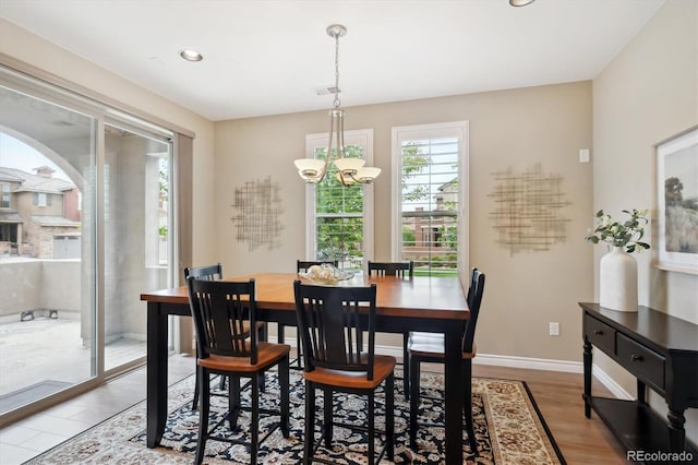 9528 Pendio Ct, Highlands Ranch, CO 80126 - dining room with a chandelier, wood finished floors, recessed lighting, baseboards, and arched walkways