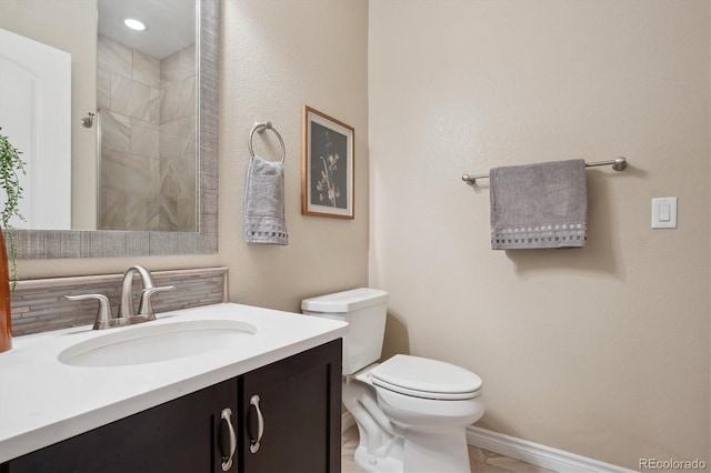 9528 Pendio Ct, Highlands Ranch, CO 80126 - full bath with toilet, vanity, decorative backsplash, a tile shower, and baseboards