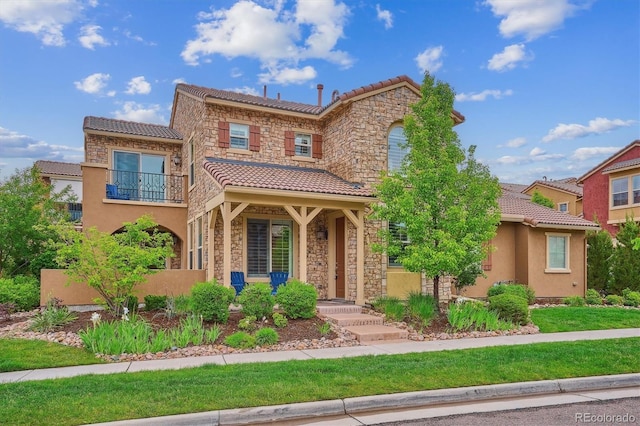 9528 Pendio Ct, Highlands Ranch, CO 80126 - view of front of home with a tiled roof, stone siding, a balcony, and stucco siding