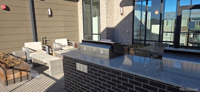 view of patio with an outdoor kitchen and area for grilling