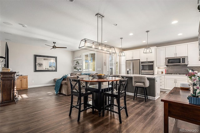 dining area featuring dark hardwood / wood-style floors and ceiling fan