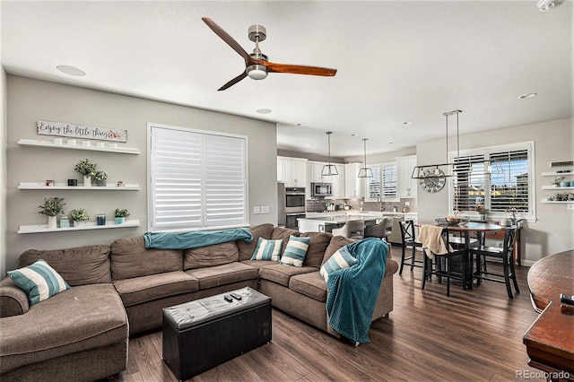 living room featuring dark hardwood / wood-style flooring and ceiling fan