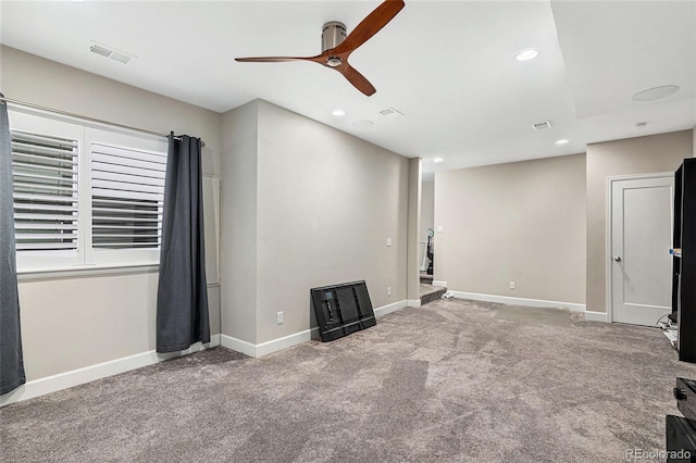 interior space with carpet floors and ceiling fan