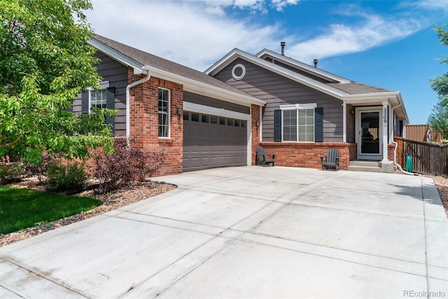 2209 Lupine Pl, Erie, CO 80516 - single story home featuring brick siding, an attached garage, and concrete driveway