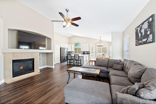 2209 Lupine Pl, Erie, CO 80516 - living area featuring lofted ceiling, ceiling fan, dark wood-style floors, a tile fireplace, and a chandelier