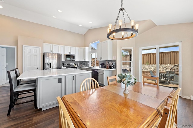 2209 Lupine Pl, Erie, CO 80516 - dining space featuring a chandelier, dark wood-style floors, high vaulted ceiling, and recessed lighting