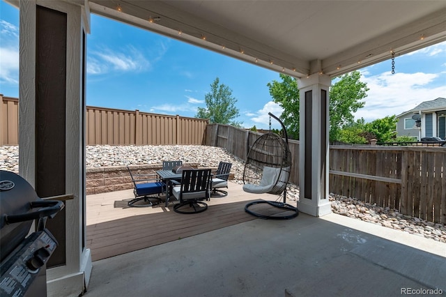 2209 Lupine Pl, Erie, CO 80516 - fenced backyard featuring grilling area, outdoor dining space, a patio area, and a wooden deck