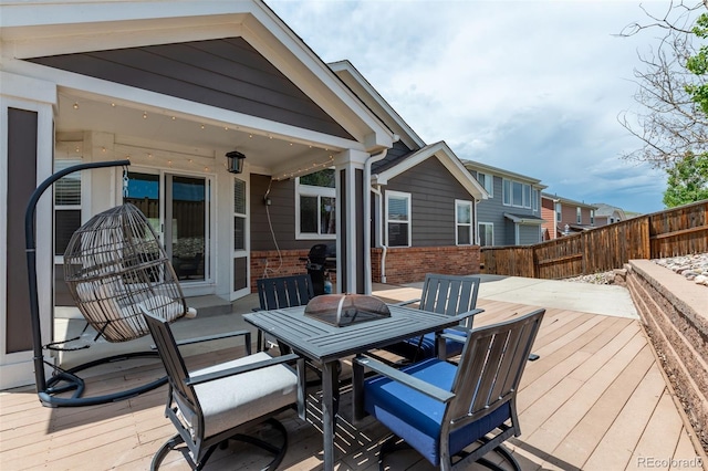 2209 Lupine Pl, Erie, CO 80516 - wooden deck featuring a fenced backyard and outdoor dining space