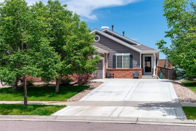 2209 Lupine Pl, Erie, CO 80516 - view of front facade with brick siding, a garage, and concrete driveway