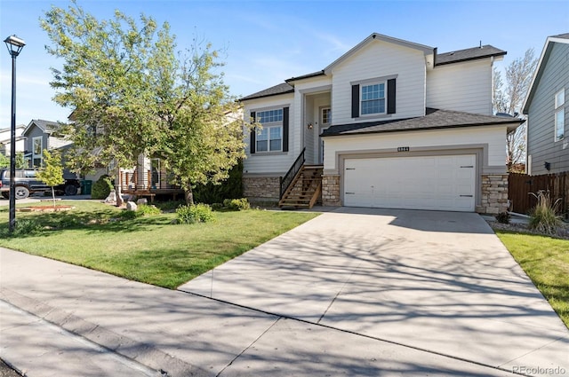 8864 S Field Ct, Littleton, CO 80128 - view of front of home featuring concrete driveway, a garage, and stone siding