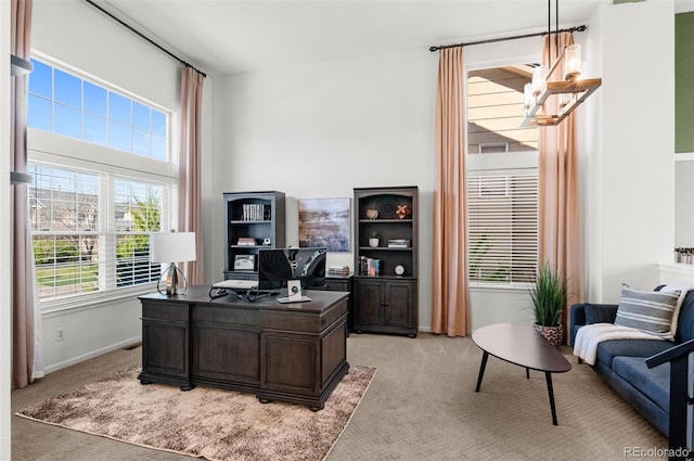 8864 S Field Ct, Littleton, CO 80128 - home office with a chandelier, light carpet, baseboards, and a towering ceiling