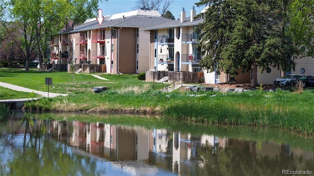 12120 Melody Dr Unit 308, Westminster, CO 80234 - rear view of house featuring a water view, a chimney, and stucco siding
