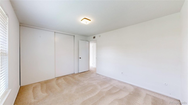12120 Melody Dr Unit 308, Westminster, CO 80234 - unfurnished bedroom featuring light colored carpet and a closet