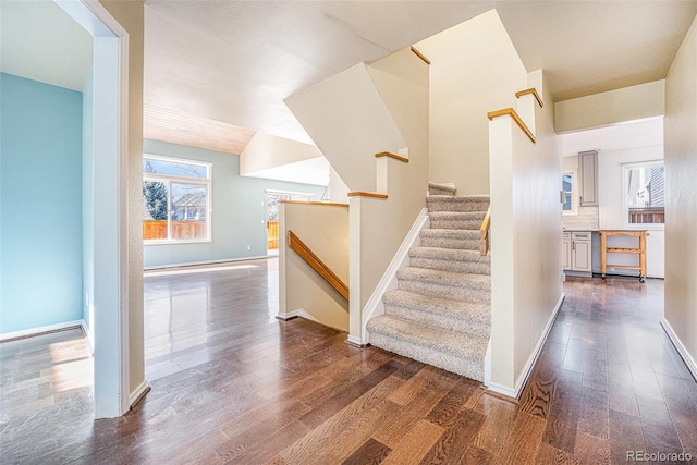 stairs with hardwood / wood-style flooring and plenty of natural light