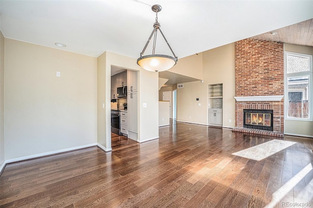 unfurnished living room with a fireplace and dark hardwood / wood-style floors