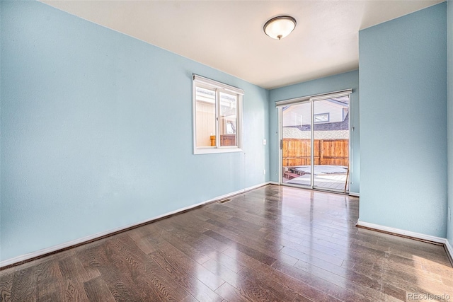 spare room with wood-type flooring