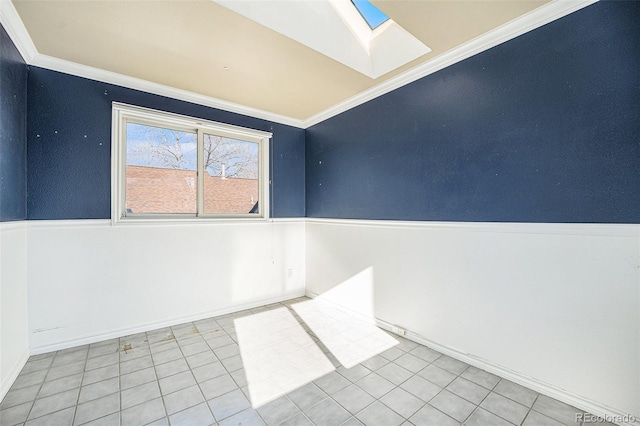 spare room featuring light tile patterned floors, crown molding, and a skylight