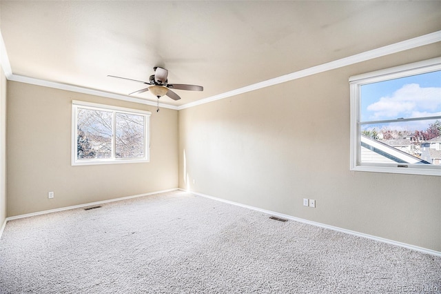 carpeted empty room featuring crown molding and ceiling fan