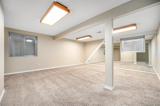 basement featuring carpet floors and a textured ceiling