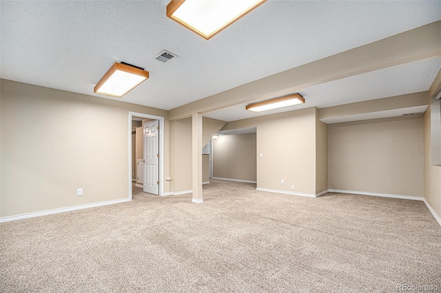 basement with carpet flooring and a textured ceiling