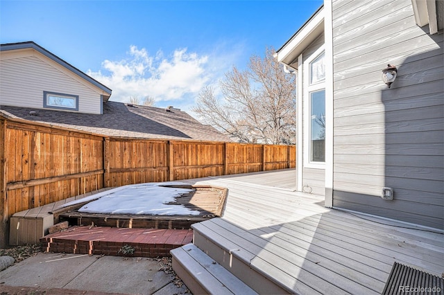 wooden deck with a hot tub