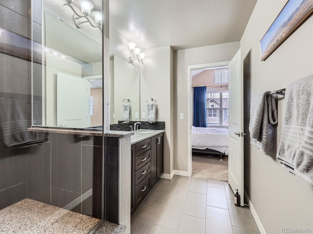 bathroom featuring tile patterned floors, vanity, and a textured ceiling