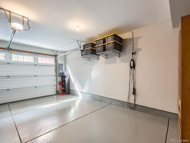 garage with a garage door opener and electric panel