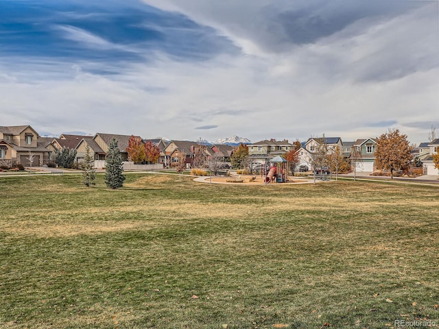 surrounding community with a lawn and a playground