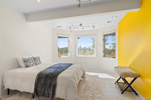 tiled bedroom featuring beam ceiling