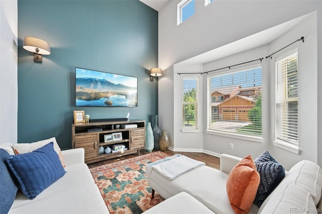 18173 E Saskatoon Pl, Parker, CO 80134 - living area featuring a towering ceiling and wood finished floors
