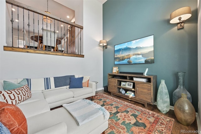 18173 E Saskatoon Pl, Parker, CO 80134 - living room featuring wood finished floors, a towering ceiling, and recessed lighting