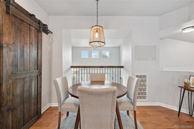 18173 E Saskatoon Pl, Parker, CO 80134 - dining area featuring wood finished floors and a barn door