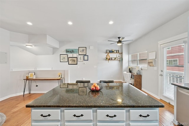 18173 E Saskatoon Pl, Parker, CO 80134 - kitchen with ceiling fan, light wood-style flooring, white cabinets, stainless steel dishwasher, and recessed lighting