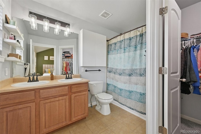 18173 E Saskatoon Pl, Parker, CO 80134 - bathroom featuring a walk in closet, double vanity, and curtained shower
