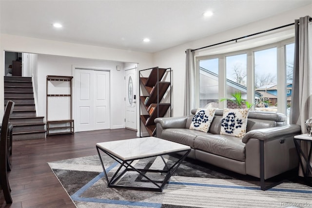 living area with recessed lighting, dark wood-style flooring, and stairway