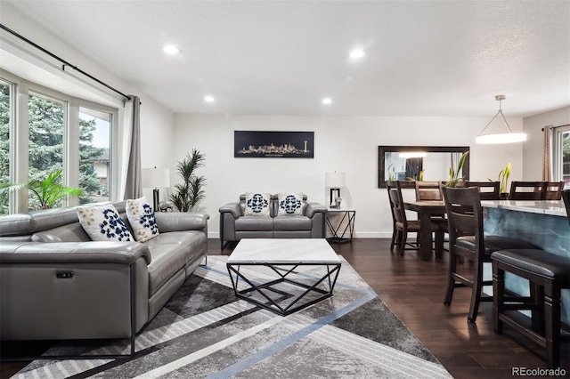 living room with dark wood-type flooring, recessed lighting, and baseboards