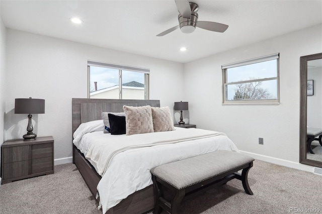 carpeted bedroom featuring recessed lighting, multiple windows, and baseboards