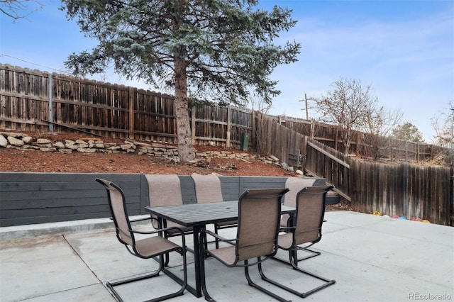 view of patio with outdoor dining space and a fenced backyard