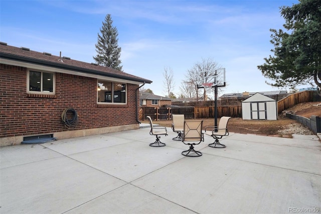 view of patio featuring a storage shed, an outdoor structure, and a fenced backyard