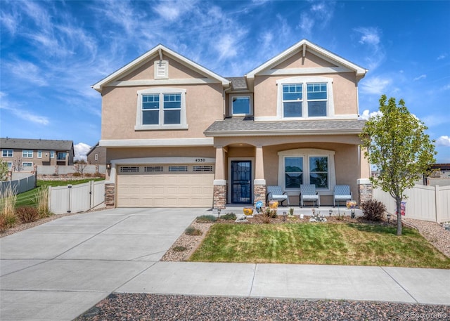 4330 Prairie Agate Dr, Colorado Springs, CO 80938 - craftsman-style house with stucco siding, a porch, a garage, concrete driveway, and stone siding