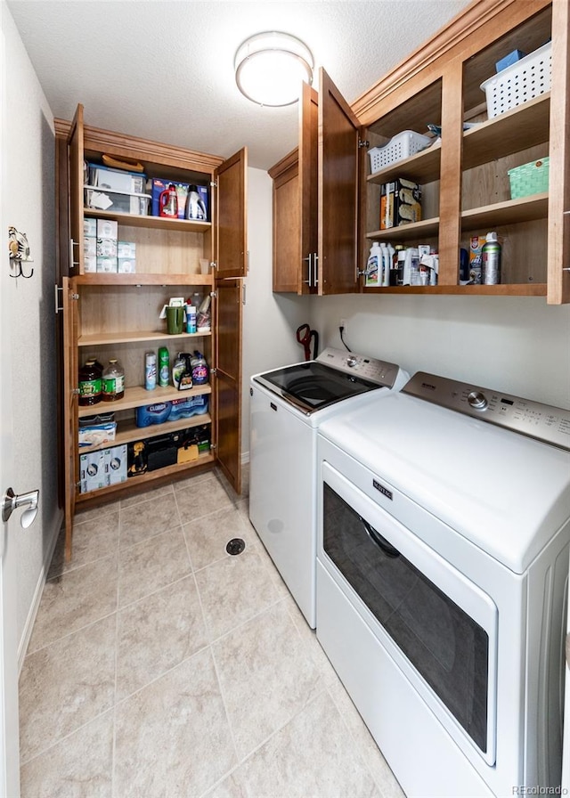 4330 Prairie Agate Dr, Colorado Springs, CO 80938 - laundry room featuring cabinet space, washing machine and dryer, and light tile patterned floors